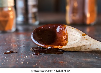 Homemade BBQ Sauce Dripping From A Wood Spoon