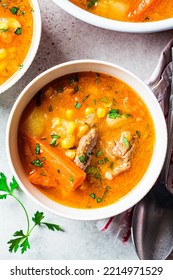 Homemade Beef Meat Soup With Carrot, Potato, Corn And Sweet Potato In White Bowl. Winter Comfort Food Concept.