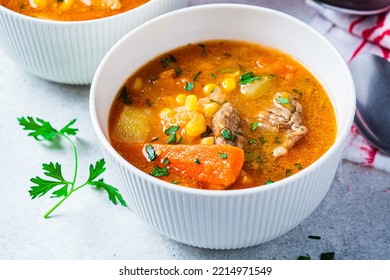 Homemade Beef Meat Soup With Carrot, Potato, Corn And Sweet Potato In White Bowl. Winter Comfort Food Concept.