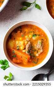 Homemade Beef Meat Soup With Carrot, Potato, Corn And Sweet Potato In White Bowl. Winter Comfort Food Concept.