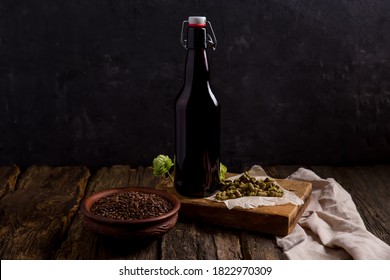 Homemade Beer, Glass Bottle And Ingredients For Making Beer. Hops, Malt On A Dark Background. Background Image