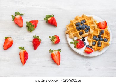 Homemade belgian waffles with  strawberries and blueberries. Delicious Breakfast with berries.