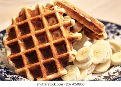 Homemade Belgium waffles served with banana slices. Selective focus. High quality photo - Powered by Shutterstock