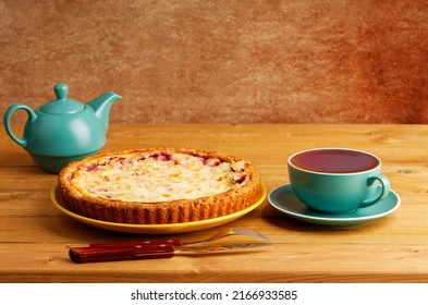 Homemade Berry Pie And Cup Of Tea On Wooden Table. Copyspace.