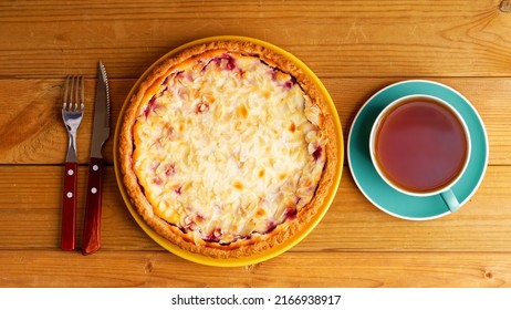 Homemade Berry Pie And Cup Of Tea On Wooden Table. Top View.