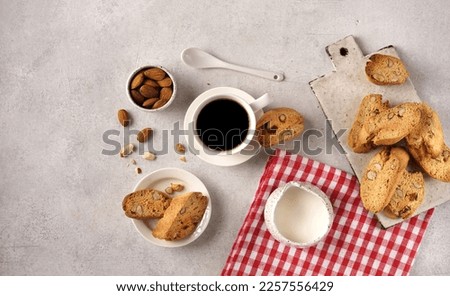 Homemade biscotti with almond and with espresoo coffee on a red napkin with cream, top vie , copy space Photo stock © 