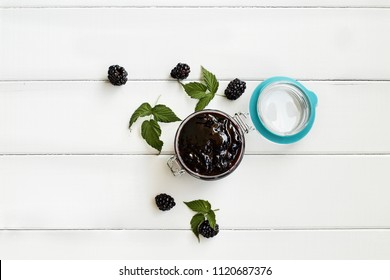 Homemade Blackberry Preserves In A Canning Glass Bail Jar With Attached Lid. Image Shot From Overhead With Focus On Jam.