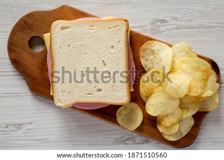 Similar – Image, Stock Photo Cheese Board with Ham, Cheese and a Knife