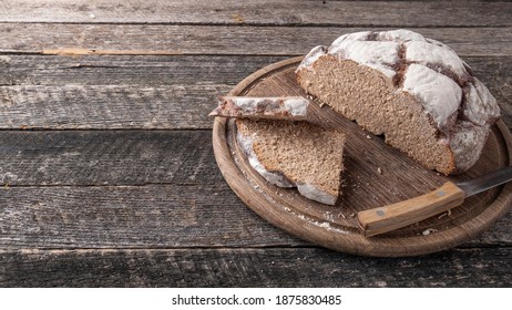 Homemade bread loaves on a wooden board. Text space - Shutterstock ID 1875830485
