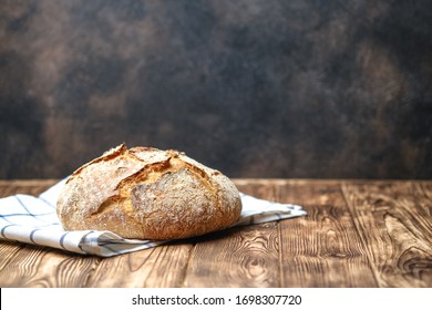 Homemade bread on a on rustic background copy space. - Shutterstock ID 1698307720