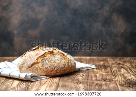 Homemade bread on a on rustic background copy space.