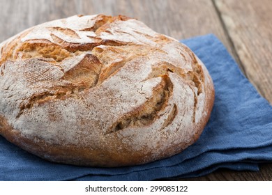 Homemade bread on wooden table - Shutterstock ID 299085122