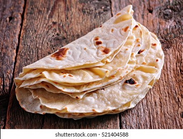 Homemade bread (pita, lavash bread) on old wooden background.