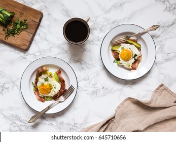 Homemade Breakfast Eggs With Bacon On A White Plates With Coffee Served On A White Marble Table Surface With Coffee And Cloth