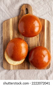 Homemade Brioche Hamburger Buns On A Wooden Board, Top View. Flat Lay, Overhead, From Above. 