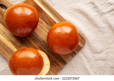 Homemade Brioche Hamburger Buns On A Wooden Board, Top View. Flat Lay, Overhead, From Above. Copy Space.