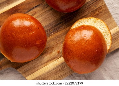 Homemade Brioche Hamburger Buns On A Wooden Board, Top View. Flat Lay, Overhead, From Above. 