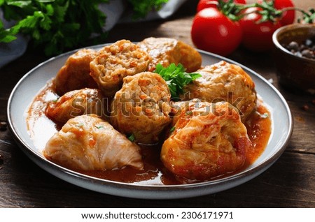 Homemade Cabbage rolls with meat, rice and vegetables. Stuffed cabbage leaves also known as sarma, golubtsy, dolma on Dark Rustic Background