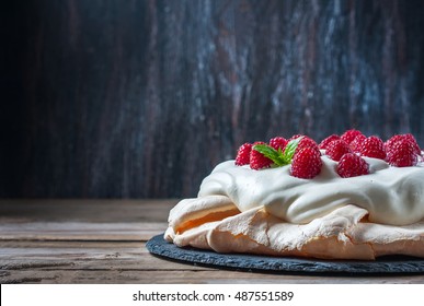 Homemade cake "Pavlova" with whipped cream and fresh raspberry. Selective focus