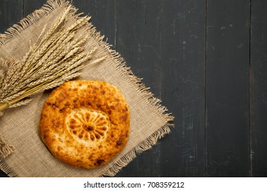 Homemade cake with whole wheat flour with apples on a wooden background. Food photo with hands and flowers. Useful dietary baking. Flat lay, top view