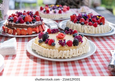Homemade cakes from summer berries and edible flowers on the festive table, party cake. - Shutterstock ID 2166129331
