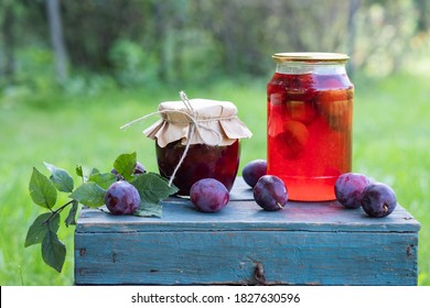 Homemade Canned Plum Compote In Large Glass Jars On Wooden Box.  Rustic Style, Selective Focus