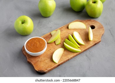 Homemade Caramel Apple Dip On A Rustic Wooden Board, Side View.