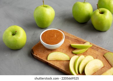 Homemade Caramel Apple Dip On A Rustic Wooden Board, Side View. 