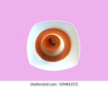 Homemade Caramel Custard Pudding With Mint In White Plate Isolated On Pink Background