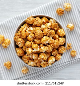 Homemade Caramel Popcorn In A Gray Bowl On A White Wooden Background, Top View. Flat Lay, Overhead, From Above.