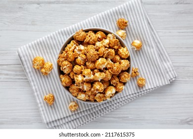 Homemade Caramel Popcorn In A Gray Bowl On A White Wooden Table, Top View. Flat Lay, Overhead, From Above.