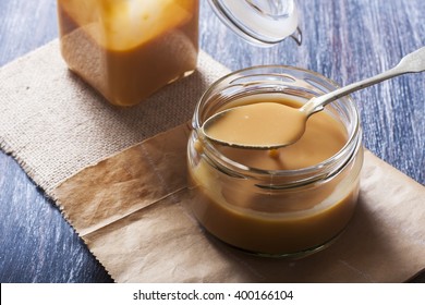 Homemade Caramel Sauce In A Glass Jar. Selective Focus