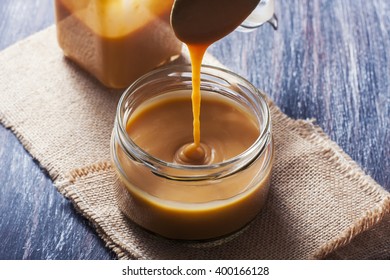 Homemade Caramel Sauce In A Glass Jar. Selective Focus