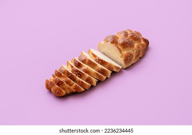 Homemade challah bread minimalist on a purple table. Delicious braided bread in bright light on colorful background - Powered by Shutterstock