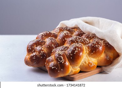 Homemade Challah with white cover -  special bread in Jewish cuisine.Main ingredients are eggs, white flour, water, sugar, salt  and yeast. Decorated  with sesame and poppy seeds.
