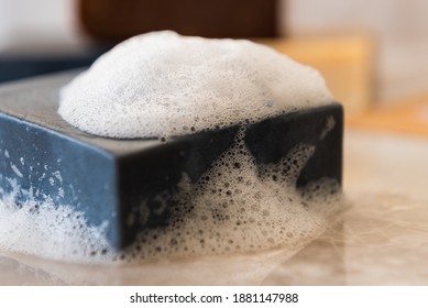 Homemade Charcoal Soap Covered In Sudsy Bubbles