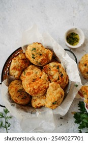 Homemade cheddar biscuits topped with garlic butter and parsley