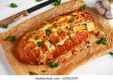 Homemade Cheese Garlic Pull Apart Bread With Herbs On Crumpled Paper