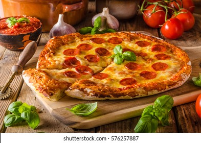 Homemade cheese pizza with salami, delicious pizza with cheddar - Powered by Shutterstock