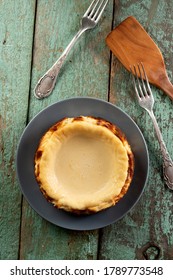 Homemade Cheesecake On The Old Painted Wood With Wooden Spatula Overhead View