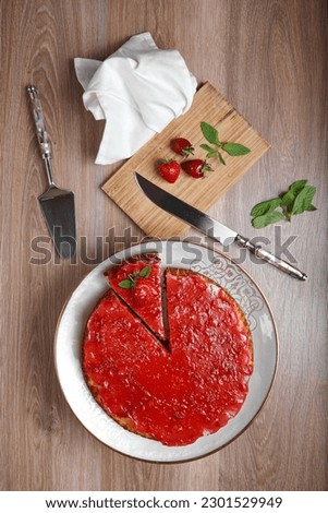 Homemade cheesecake with strawberries with fruit and sauce full service woodbackground