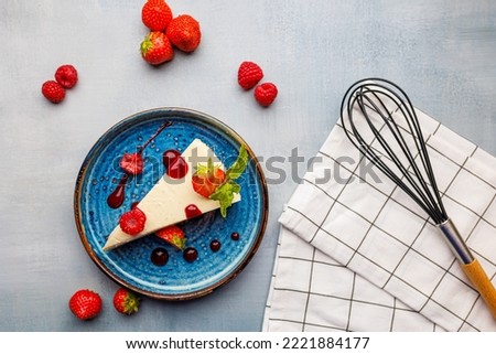 Homemade cheesecake with strawberries and raspberries. The perfect desert for a hot summer day. Top down image - flat lay.