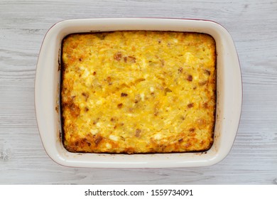 Homemade Cheesy Amish Breakfast Casserole On A White Wooden Surface, Top View. Flat Lay, Overhead, From Above. Closeup.