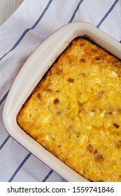 Homemade Cheesy Amish Breakfast Casserole On A White Wooden Surface, Top View. Flat Lay, Overhead, From Above. Closeup.