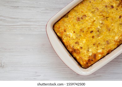 Homemade Cheesy Amish Breakfast Casserole On A White Wooden Table, Top View. Flat Lay, Overhead, From Above. Copy Space.