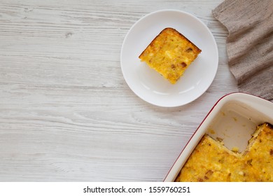 Homemade Cheesy Amish Breakfast Casserole On A White Wooden Surface, Top View. Flat Lay, Overhead, From Above. Copy Space.