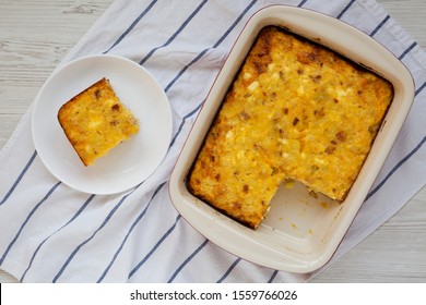 Homemade Cheesy Amish Breakfast Casserole On A White Wooden Surface, Top View. Flat Lay, Overhead, From Above. 