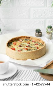 Homemade Cheesy Spinach Quiche For Brunch. Set On White Cafe Table Background.