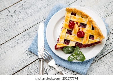 Homemade cherry pie on wooden table. Elevated view