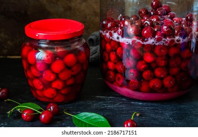 Homemade Cherry Preserves In A Glass Jar And Fresh Pitted Red Cherries Preserved In Sugar Syrup. Canned Organic Food From The Garden.